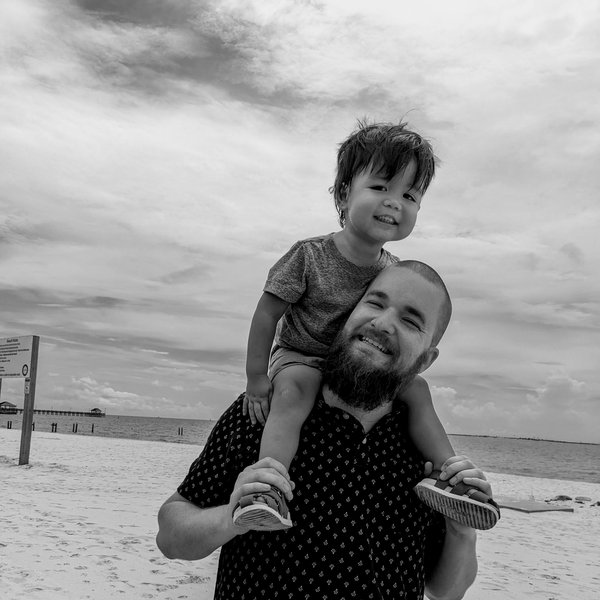 Adam Hopkins, founder of Gulf Coast Reception, with his son on the Mississippi Gulf Coast